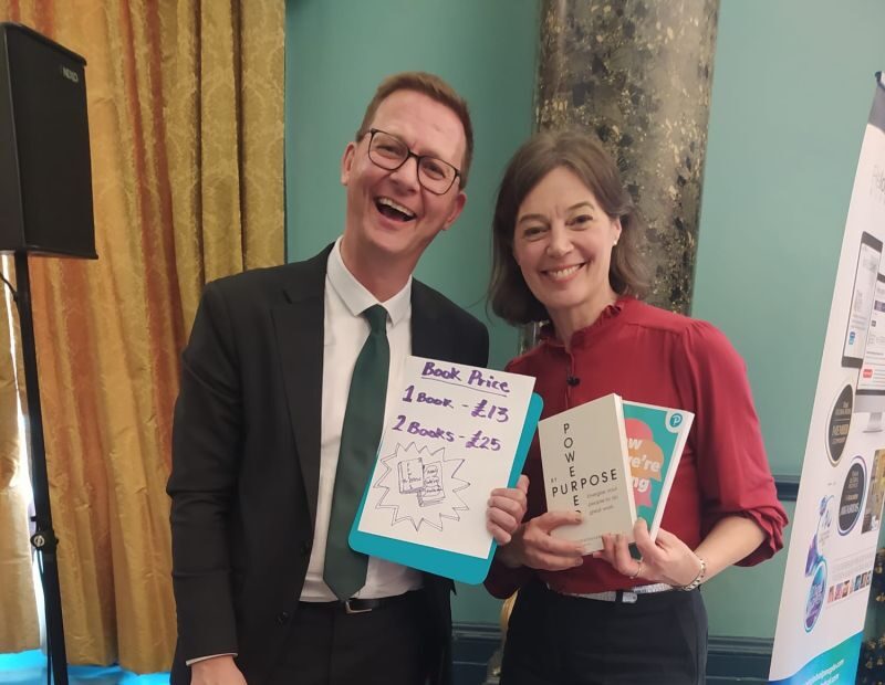Smiling man and woman with books